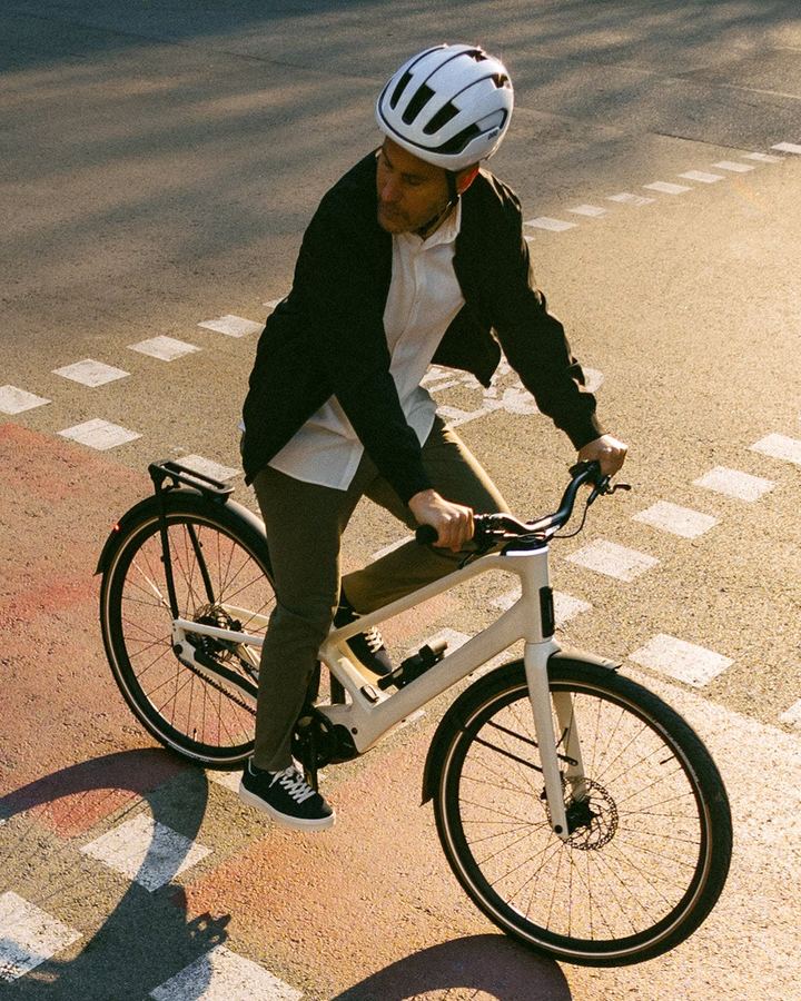 Rider on an e-bike crossing an urban intersection, seen from above