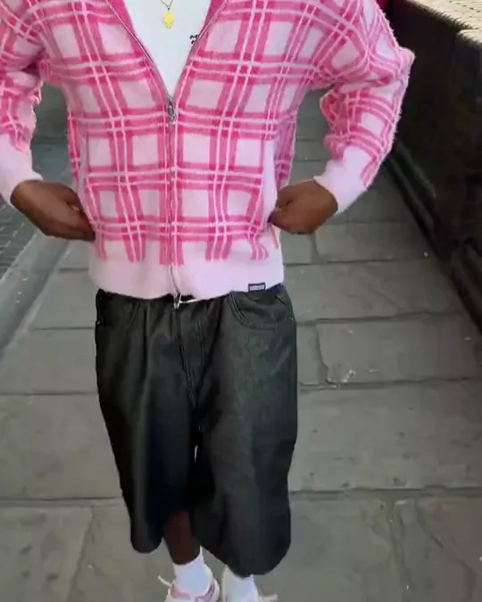 Two More Money More Love outfits in motion: pink check jacket and white jersey with the number 10