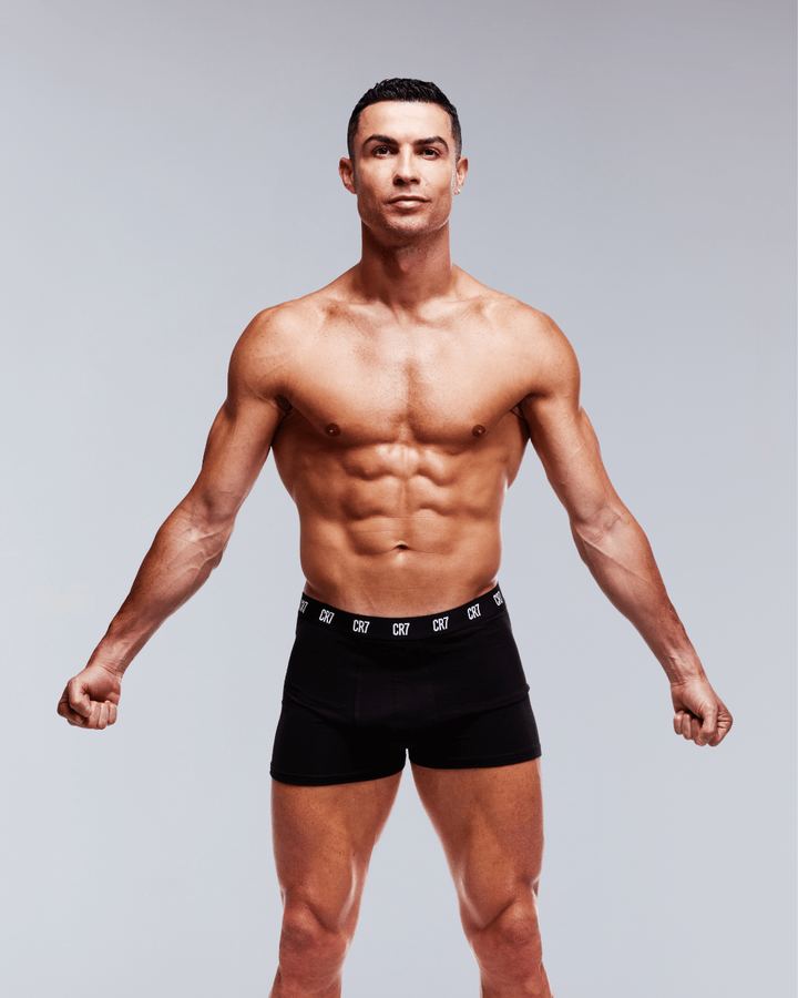 Athletic shirtless man in black CR7 boxer briefs in the studio