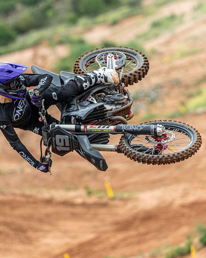 Motocross rider in O'Neal gear whipping a jump