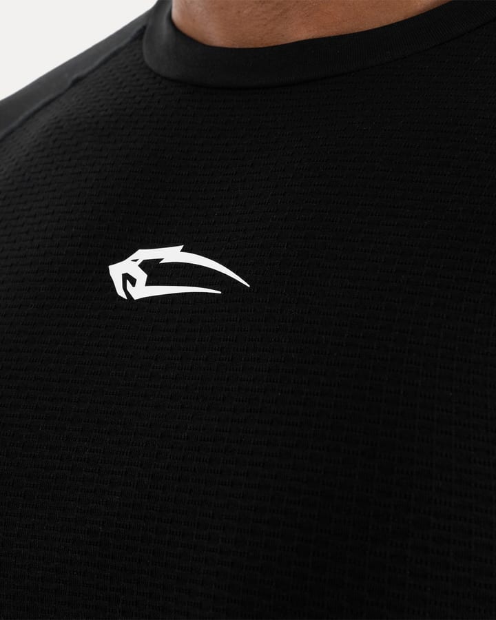 Close-up of a black performance shirt with the white Smilodox logo on the chest